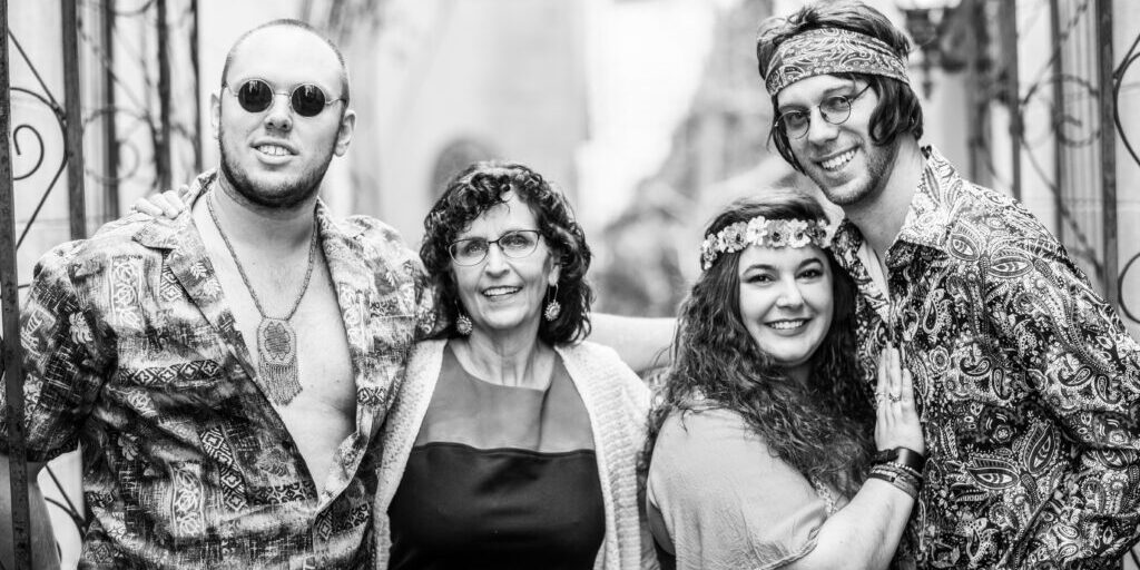Black and White image of a Quartet of Oldies Singers dressed in hippy attire.